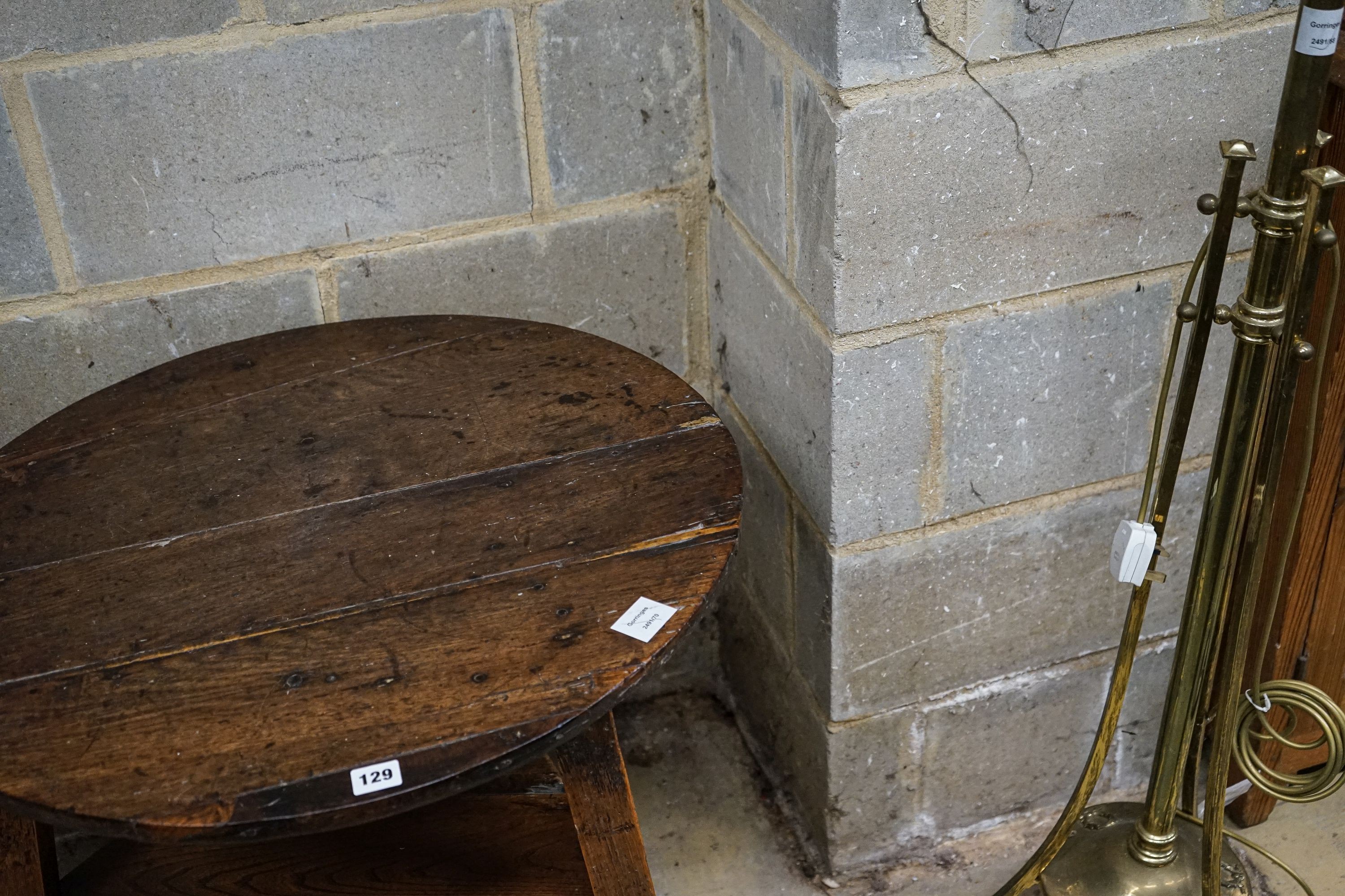 A George III oak cricket table, with circular top and triangular understage, diameter 67cm, height 65cm